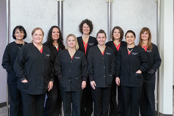 Experience the difference with our team in Reston, VA All our Reston dentistry team smiling while wearing their uniform